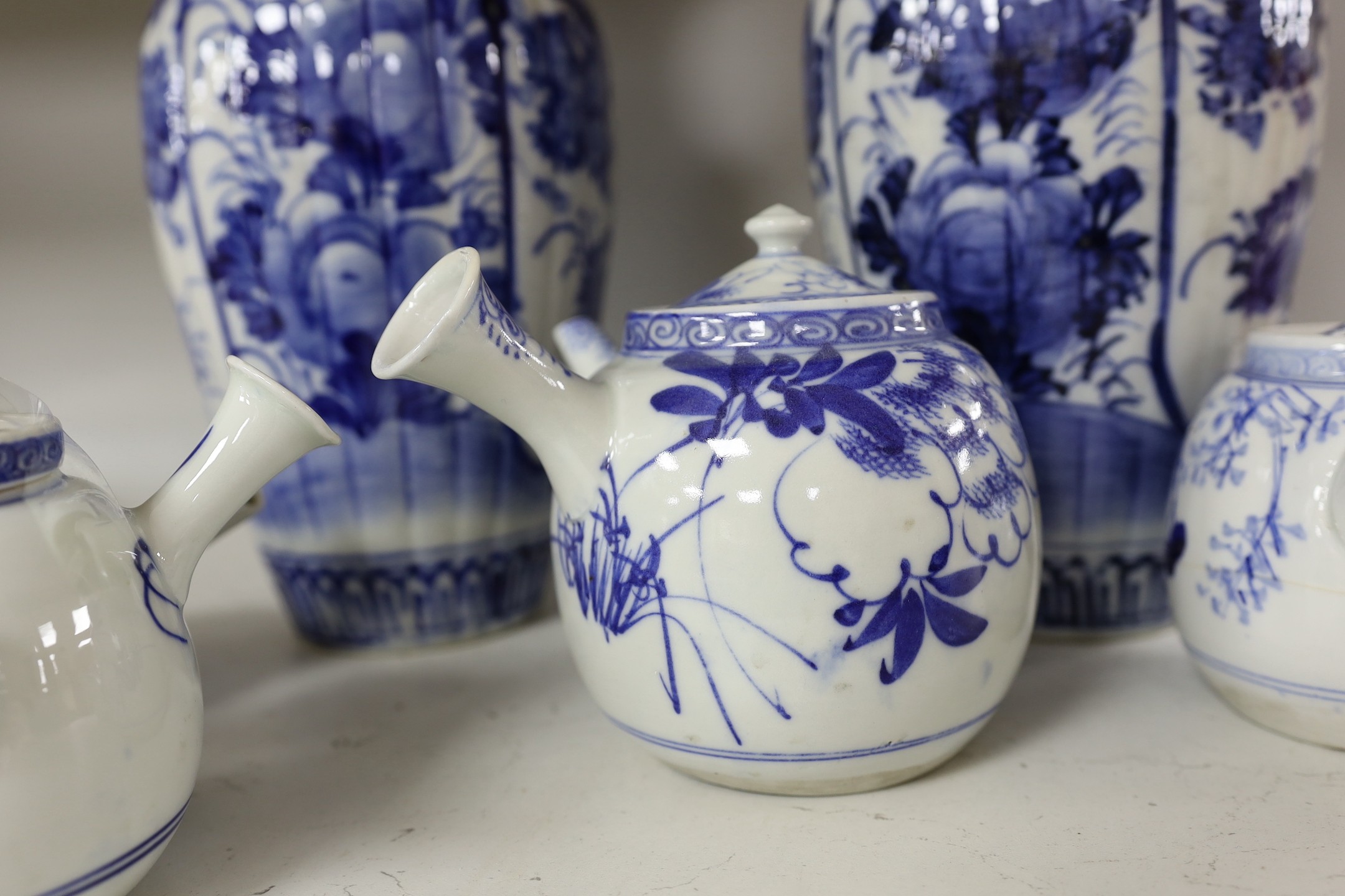 A pair of Japanese blue and white vases and various Japanese blue and white porcelain teapots and covers, tallest 30cm